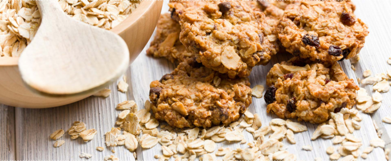 Oatmeal Cookies with Raw Oats on a Table